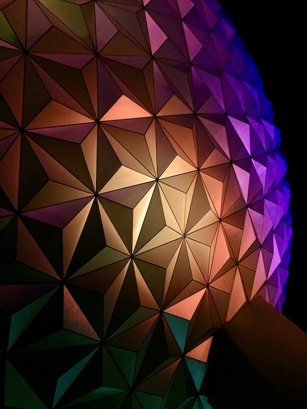 The Epcot ball at Disney World lit up in a rainbow